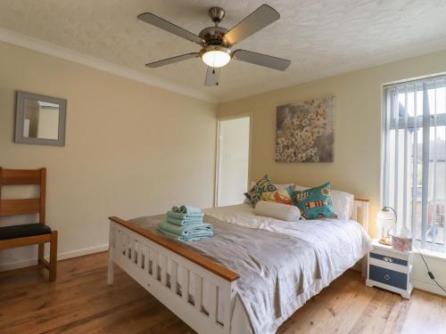 a bedroom with a bed with a ceiling fan at 122 Morton Road in Lowestoft