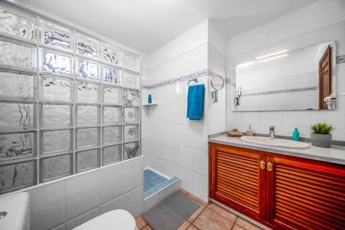 蒂亞斯的住宿－Blue Beach，浴室配有盥洗盆、卫生间和浴缸。
