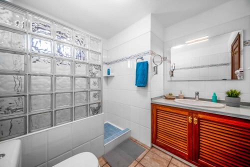 a bathroom with a sink and a toilet and a tub at Blue Beach in Tías