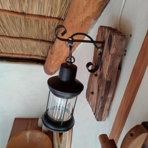 a black lantern hanging from the ceiling of a room at Pura Vida Tofo Beach Houses in Praia do Tofo
