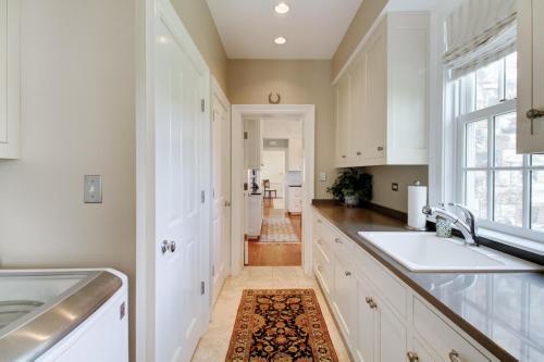 a kitchen with white cabinets and a sink and a window at Homestead Lookout in Hot Springs