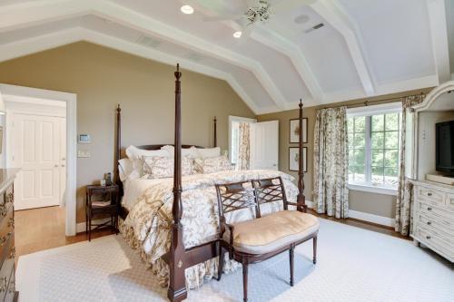 a bedroom with a canopy bed and a tv at Homestead Lookout in Hot Springs