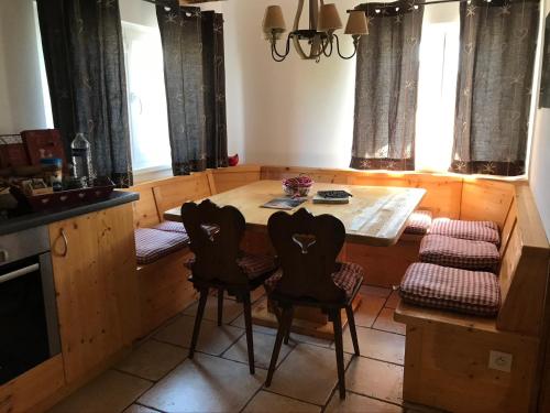 a kitchen with a table and chairs in a room at Les Authentics - Le Domaine d'Autrefois & Spa in Bolsenheim
