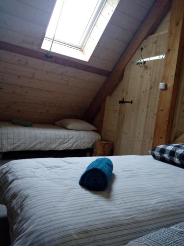 ein Schlafzimmer mit einem Bett mit einem blauen Kissen darauf in der Unterkunft La grande Ourse in Campan