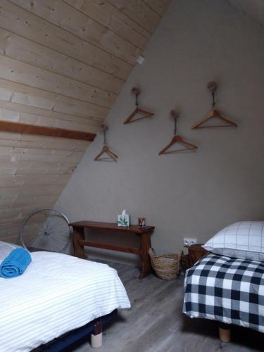 a attic bedroom with two beds and a table at La grande Ourse in Campan