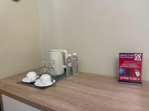 a counter with a coffee maker and a book on it at Aura Almaty in Almaty