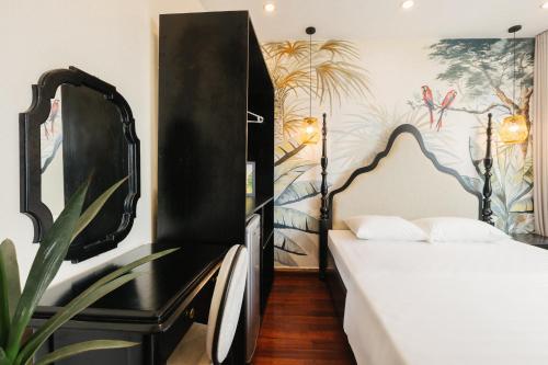 a bedroom with a black bed and a plant at Sun Clover Boutique Hotel in Hanoi
