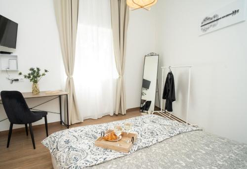 a bedroom with a bed and a desk and a mirror at Downhill Apartment with a Private Terrace in Kaunas