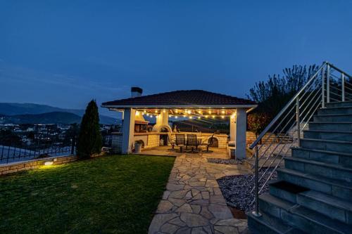 a backyard with a gazebo and stairs at night at The Urban Escape in Ioannina