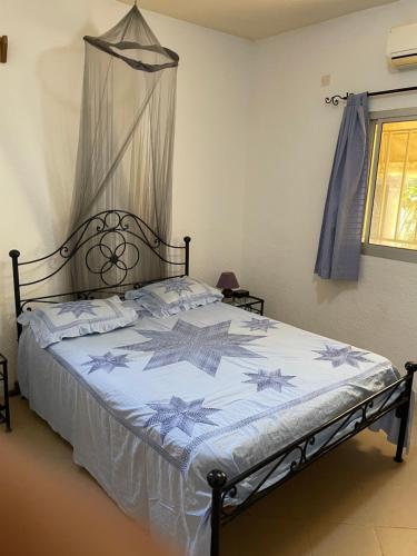1 dormitorio con 1 cama grande con dosel en VILLA SOMONE avec PISCINE PRIVÉE, en Somone