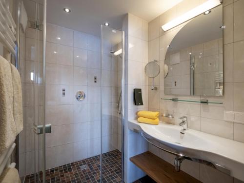 a bathroom with a sink and a shower at Berghaus Koglmoos in Auffach