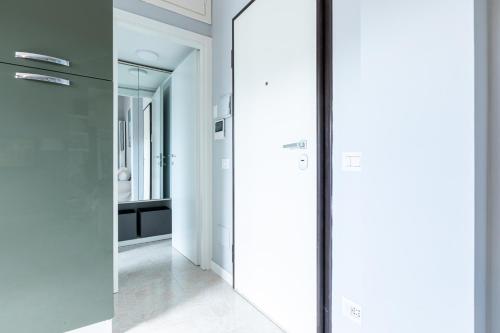 a glass door in a hallway with a mirror at Collection CityLife Suites with Terrace - Top Collection in Milan