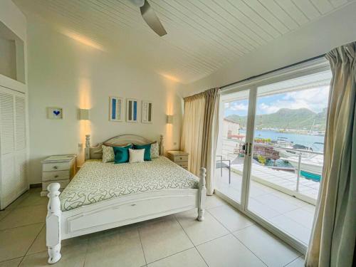 a bedroom with a bed with a view of the ocean at Villa 238A Jolly Harbour in Jolly Harbour
