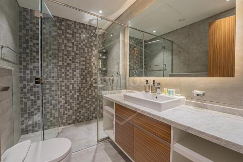 a bathroom with a sink and a shower and a toilet at KeyHost - Spacious 1BR with Parking near Five hotel in JVC - Dubai - KG10 in Dubai