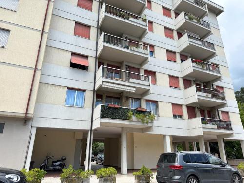 a large apartment building with cars parked in front of it at Mirea's Rooms in Ascoli Piceno