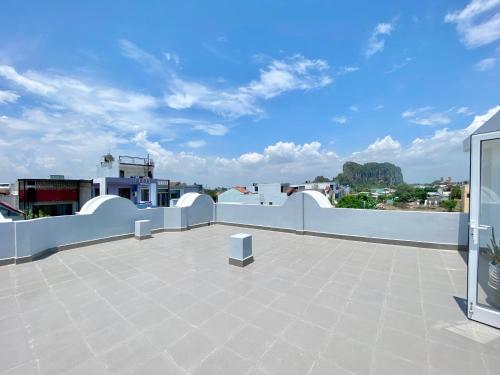a balcony with a white fence and a blue sky at Moc Son Apartment - Attractive price for week and month stay - Serene Beachside Retreat Near Marble Mountains in Da Nang