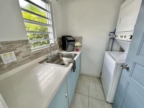 a small kitchen with a sink and a window at Villa 218E Jolly Harbour in Jolly Harbour