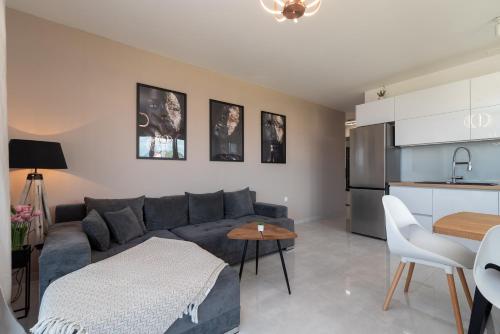 a living room with a couch and a table at Apartments Angelus in Trogir
