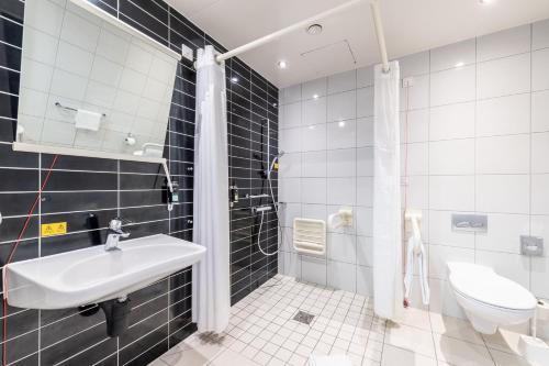 a bathroom with a sink and a toilet at Premier Inn Heidelberg City Centre in Heidelberg