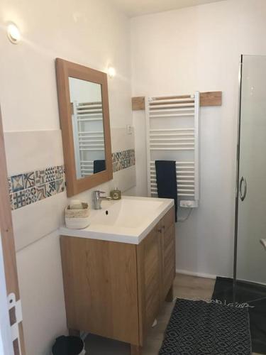 une salle de bain avec un lavabo et un miroir dans l'établissement Marmot, coeur montagne, Serre Chevalier, Col de l'Izoard, à Cervières