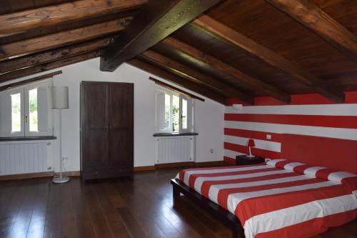 a bedroom with a red and white striped wall at Villa Pontecorvo with Swimming Pool in Sant'Agnello