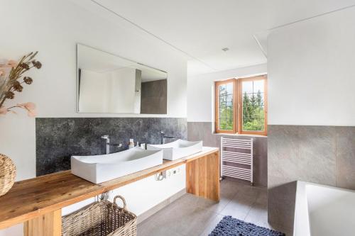 a bathroom with two sinks and a mirror at Kitzchalet in Kitzbühel