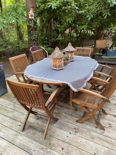 a wooden table with chairs and a blue table cloth at Chalet in Lanaken