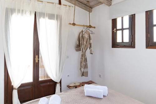 a bedroom with a bed and a window at Tethys 3 by Cretan Pnoe Adults Only in Kolymvari