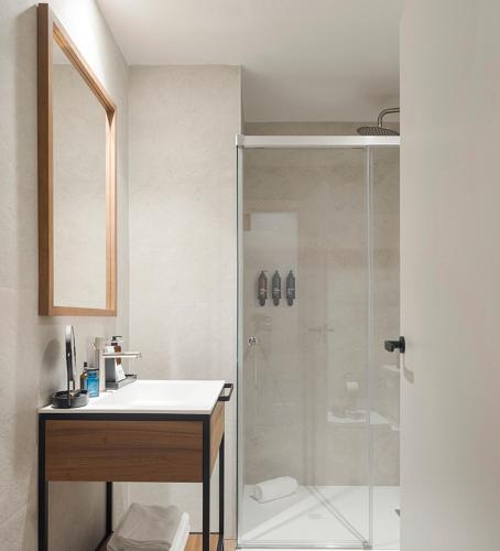 a bathroom with a shower and a sink and a toilet at Room Mate Oliveira - City Centre, Valencia in Valencia
