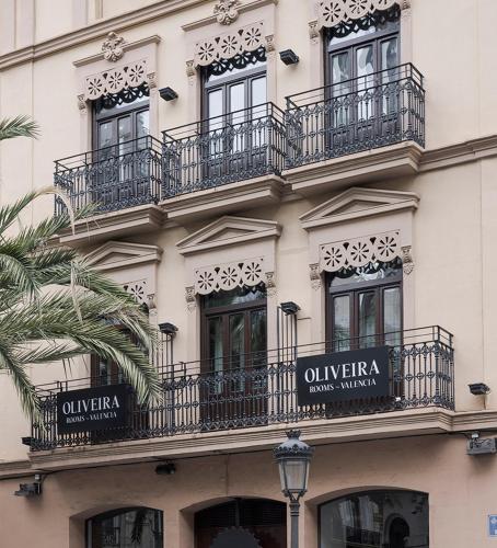 a facade of a building with balconies and a street light at Room Mate Oliveira - City Centre, Valencia in Valencia