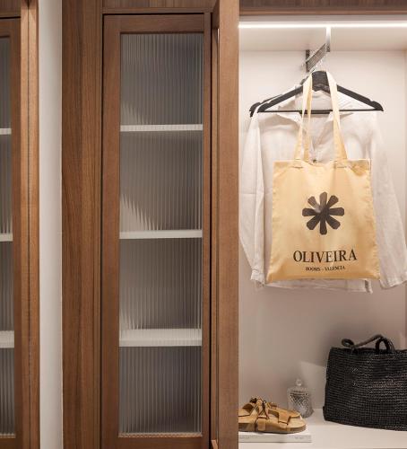 a closet with a bag and a pair of shoes at Room Mate Oliveira - City Centre, Valencia in Valencia
