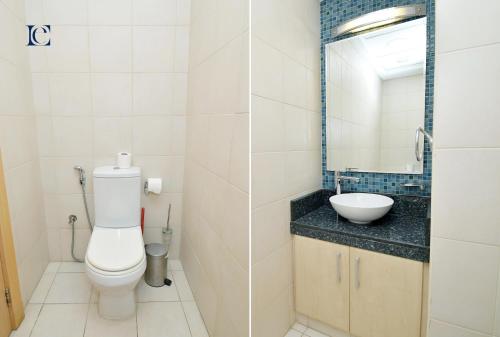 a bathroom with a toilet and a sink at Palm Jumeirah's Spectacular Ocean-View Apartment - NBT in Dubai