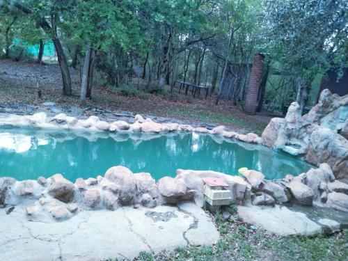 a small pool of water with rocks around it at umbabala bush camp in Rustenburg