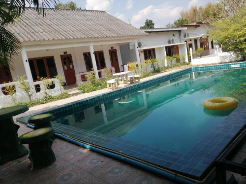 a swimming pool in front of a house at Pai Family Resort in Pai