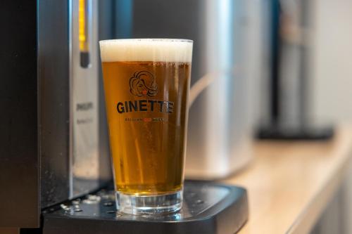 a glass of beer sitting on a table at B&B HOTEL Troyes Magasins d'usine in Troyes
