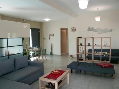 a living room with a couch and a table at Chania Olive Home in Kato Daratso