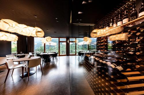 a restaurant with a bunch of wine bottles at Hotel Arnica Scuol - Adults Only in Scuol