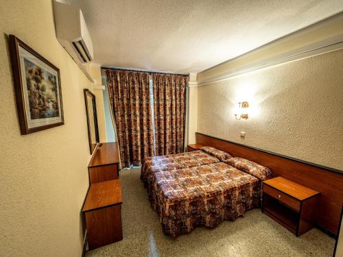 a hotel room with a bed and a window at HOTEL CONTINENTAL in Calella