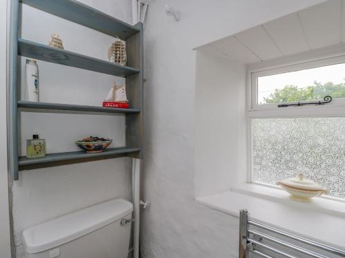 a bathroom with a toilet and a window at 9 Velley Hill in Corsham