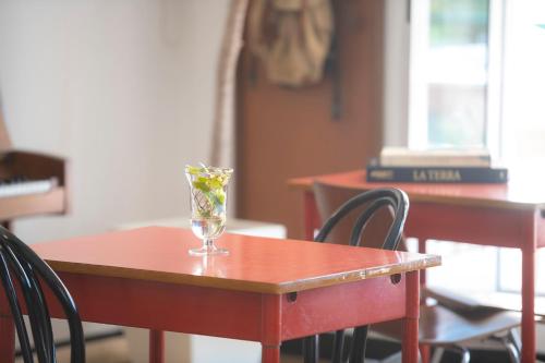 a table with a glass on top of it at Hotel San Michele in Celle Ligure