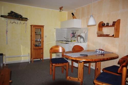 a kitchen with a table and chairs and a dining room at Ferienwohnungen Blum in Sassnitz