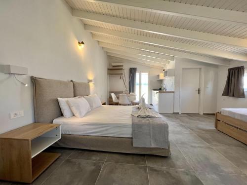 a bedroom with a large white bed in a room at Issos Residence in Agios Georgios