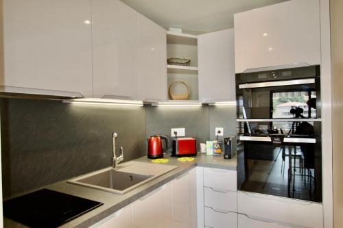 a kitchen with a sink and a stove top oven at Sea view Monaco Monte Carlo in Beausoleil