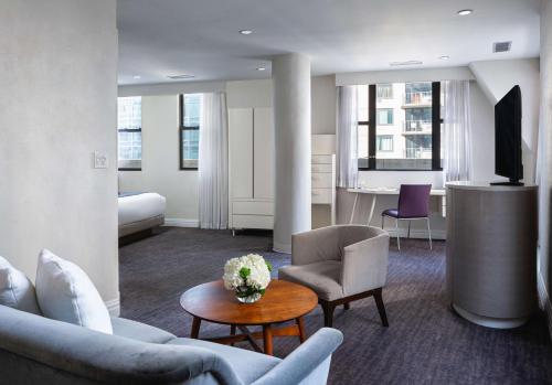 a living room with a couch and chairs and a table at Dream Midtown, Part Of Hyatt in New York