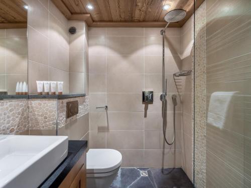 a bathroom with a shower and a toilet and a sink at Chalet Méribel, 8 pièces, 10 personnes - FR-1-565-65 in Les Allues