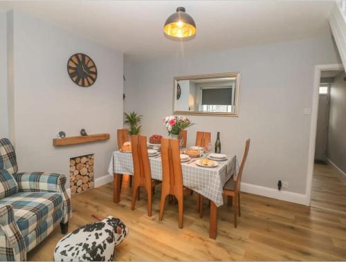 a dining room with a table and chairs at Sunshine Cottage Tideswell, Games room included. in Tideswell