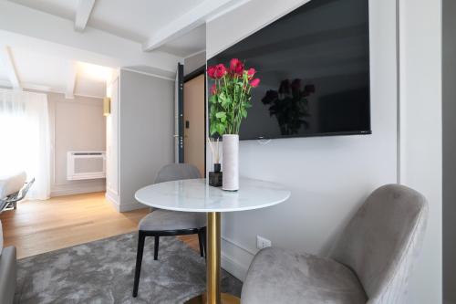 a dining room with a table and two chairs at PRESTIGE BOUTIQUE APARTHOTEL - Piazza Duomo View in Milan