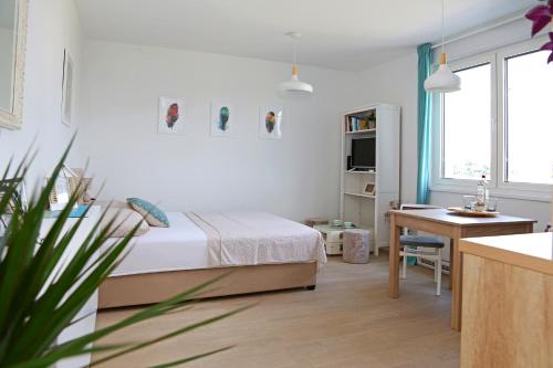 a bedroom with a bed and a desk and a table at Studio CAMINO with parking in Zadar