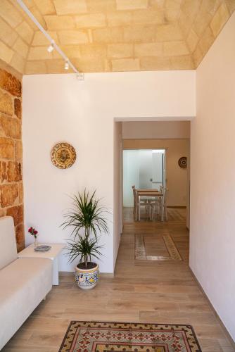 a living room with a couch and a table at Butiko in Castelluzzo