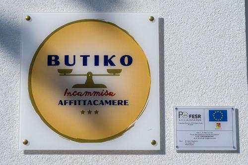 a sign on a wall that reads buffaloushimaushima antibiotic care at Butiko in Castelluzzo